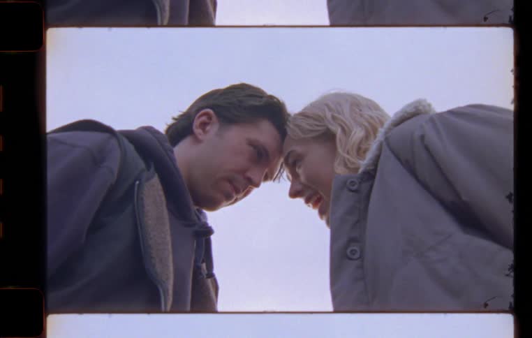 Man and woman having a conversation with their heads touching during day time