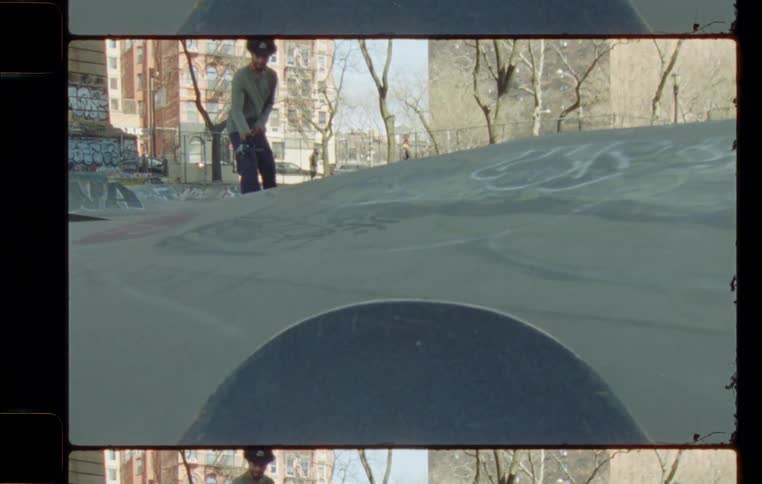 Man films skateboard riding in skatepark