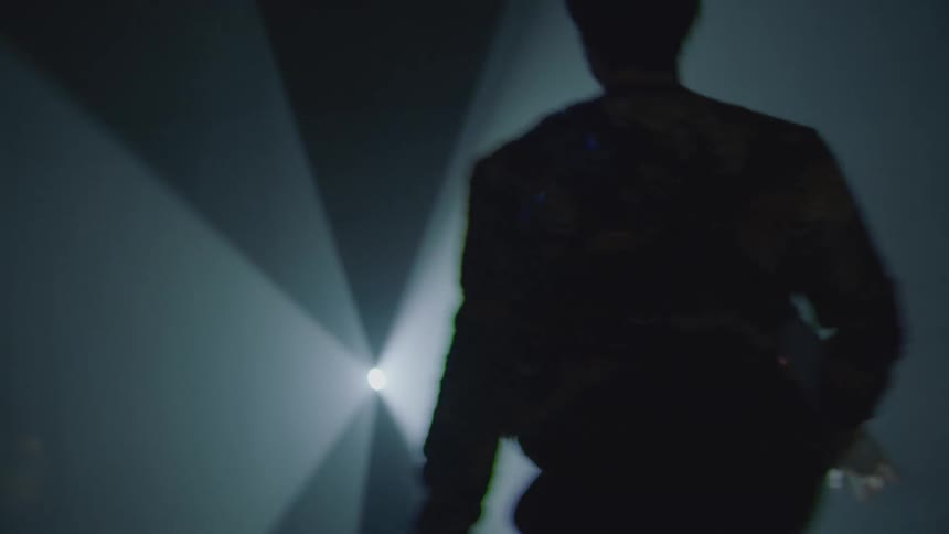 Two people dance in silhouette