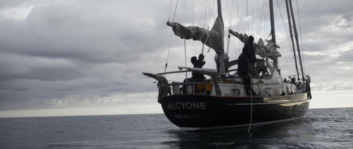 People are standing on a boat on a cloudy day
