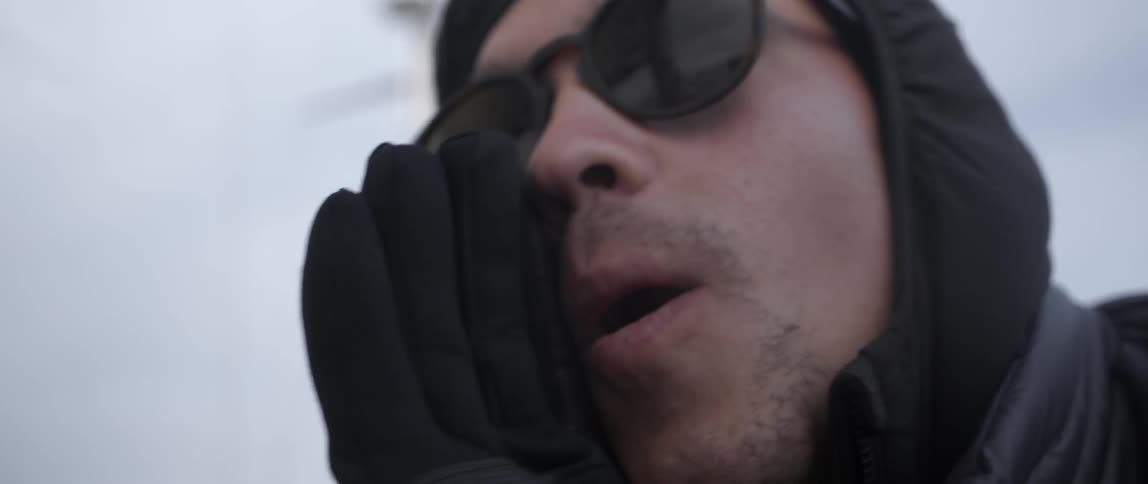 A has his hand against his mouth as he talks