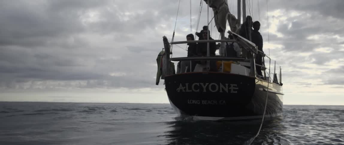 A boat has many people on it and a rope coming from it