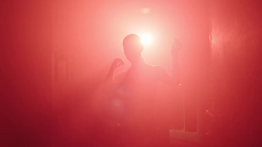 A woman is dancing in the foggynightclub
