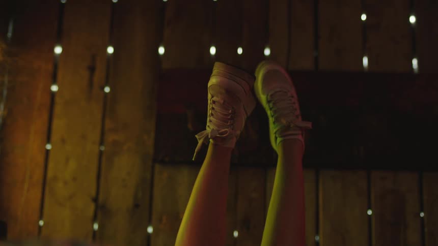 A pair of feet raised in the air dancing around each other