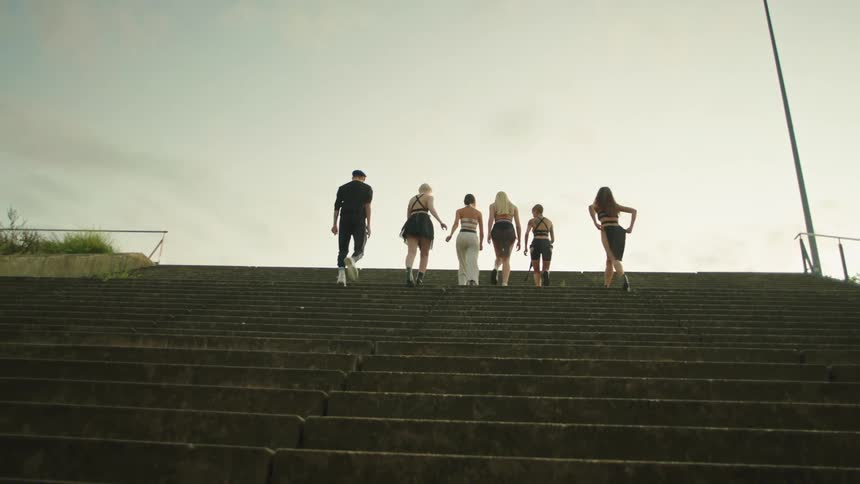 Six women climb the steps together
