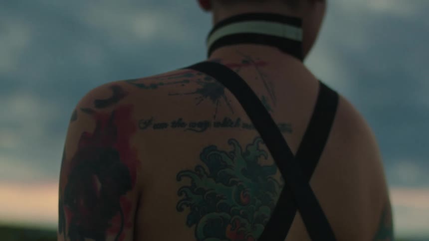 A woman has tattoos on her back