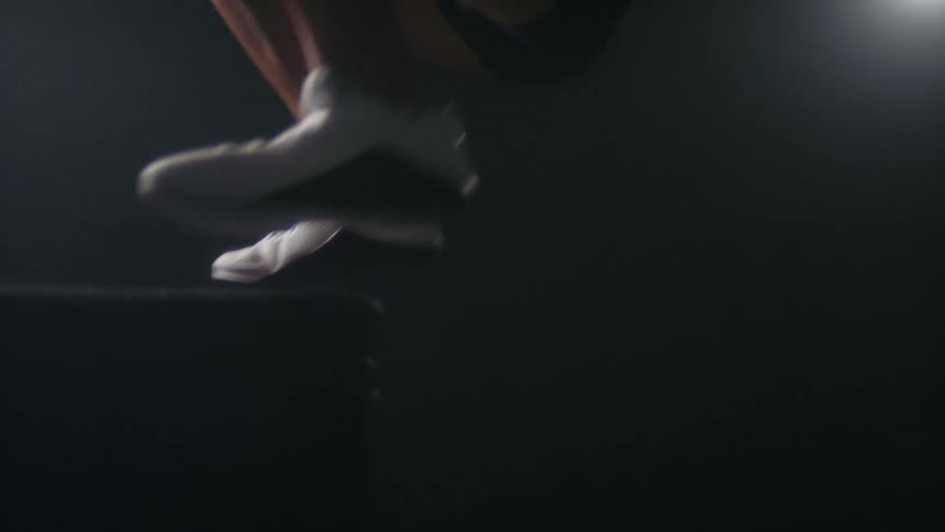 A woman jumps on the pedestal