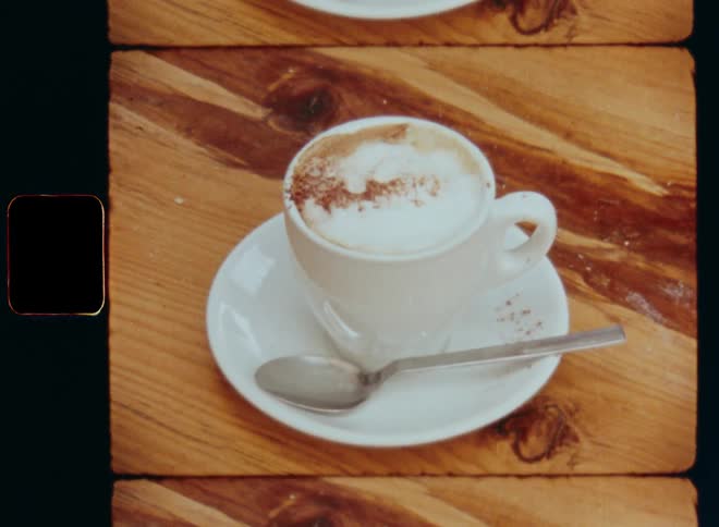 Closeup of a coffee cup with a small spoon beside it