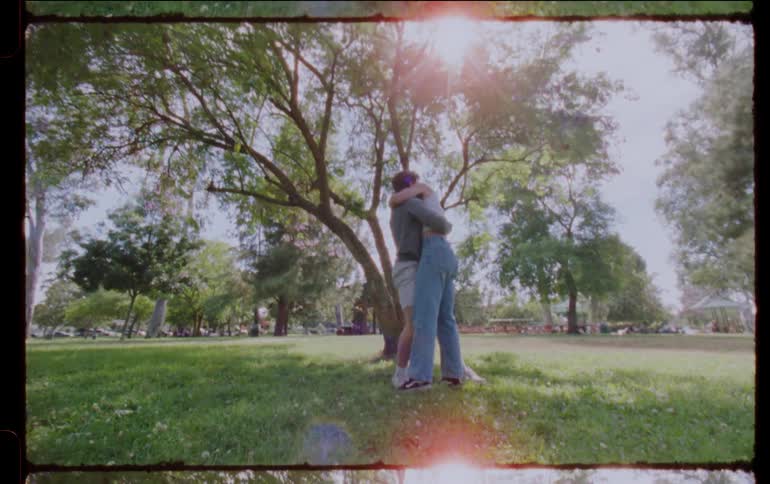 A couple hug in the park