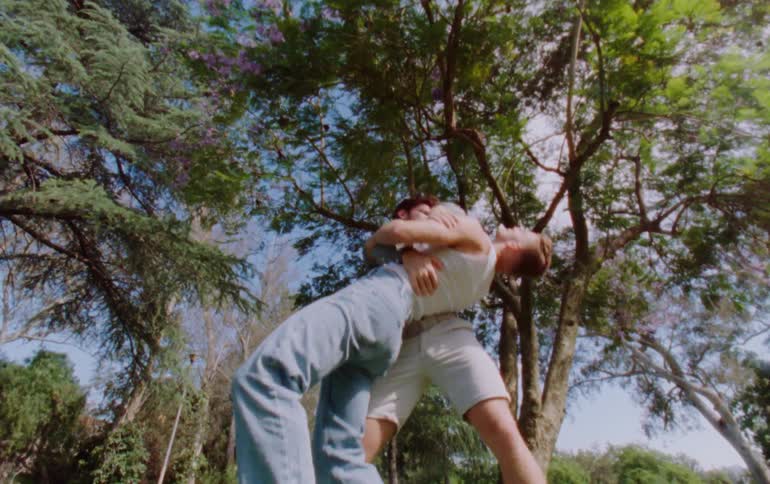 Two young dancers dance in a forest park on a sunny day