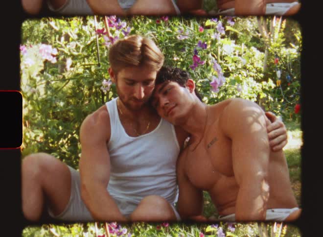 A couple sits in the flower garden on a sunny day