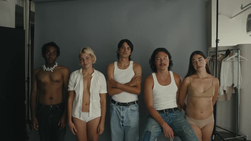A portrait of a group of young and diverse friends gaze at the camera