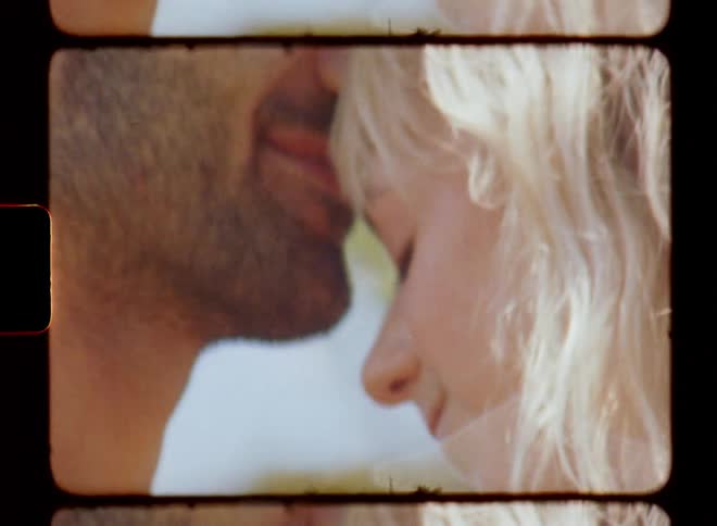 A couple in love exchanging caresses on a sunny day