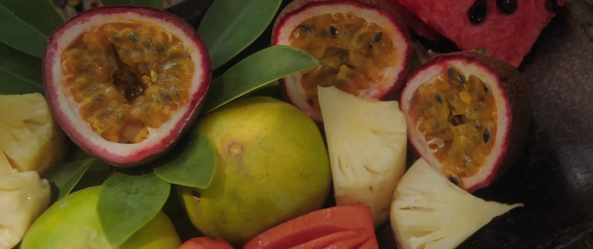 Fruits including orange and slice pineapple scattered around