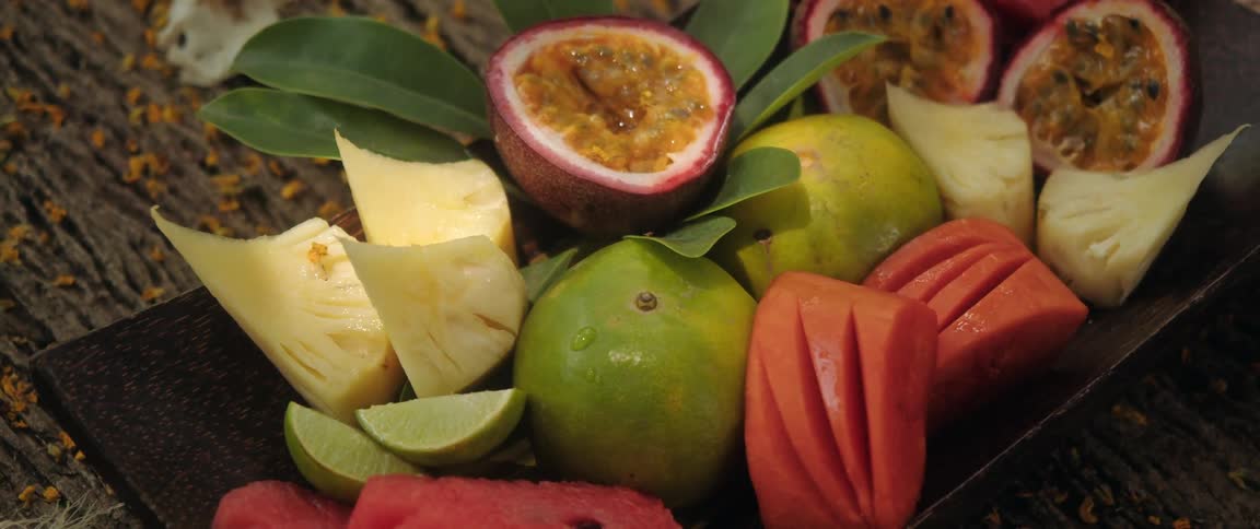 A closeup shot of various fruit on a plate on a table