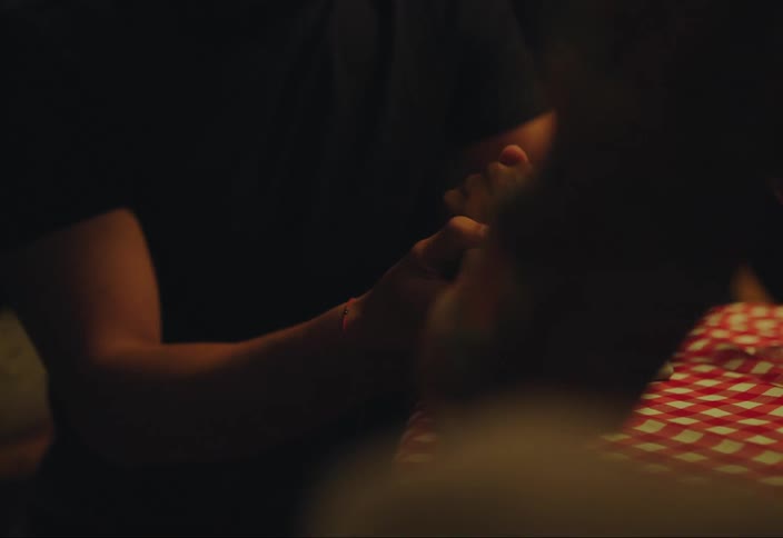 Happy man puts an engagement ring on a womans hand in a restaurant