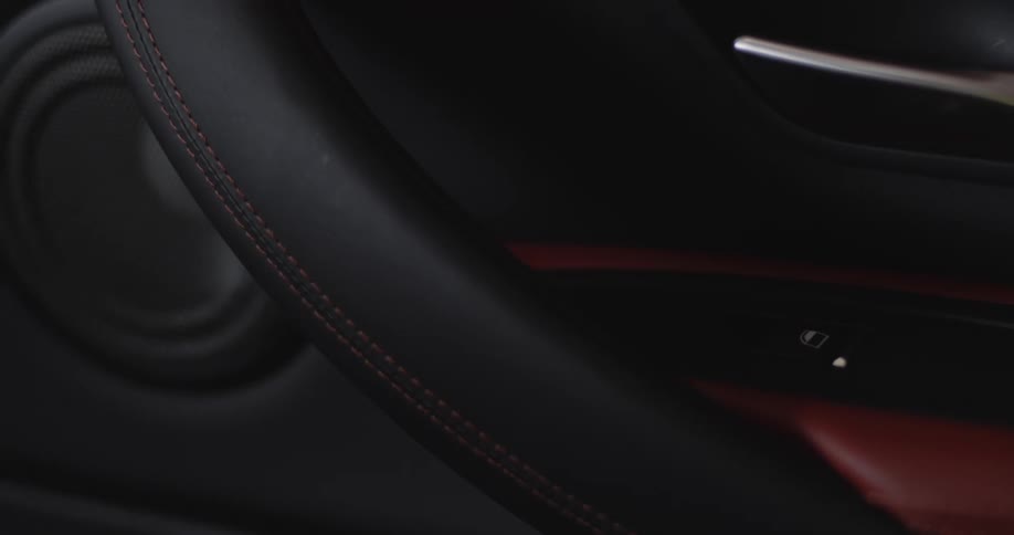 Closeup of a car interior with red and black leather design