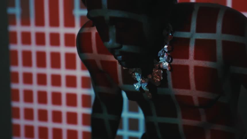 A black man moves slowly as he navigates a prison of digital consciousness