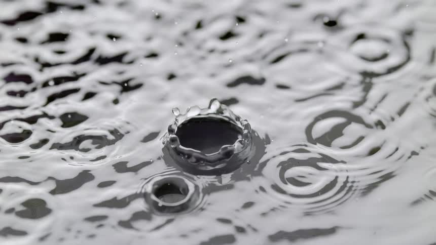 Closeup of raindrops falling into the lake