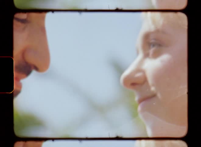 A man and a woman looking at each other and embracing passionately