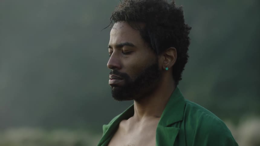 Close up of a man outdoors moving aggressively and breathing slowly