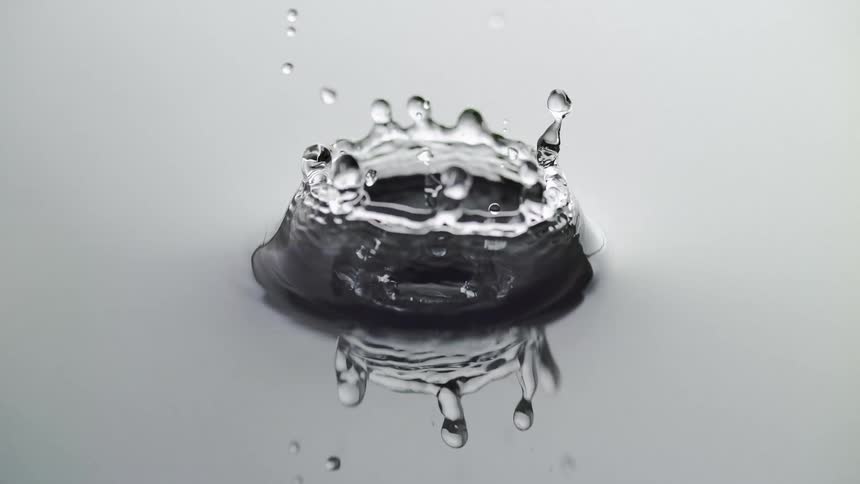 A drop of water falls in the liquid