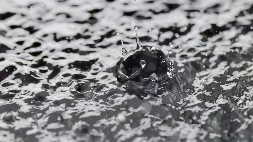 Water droplets splashing on the surface of rough waters during the day