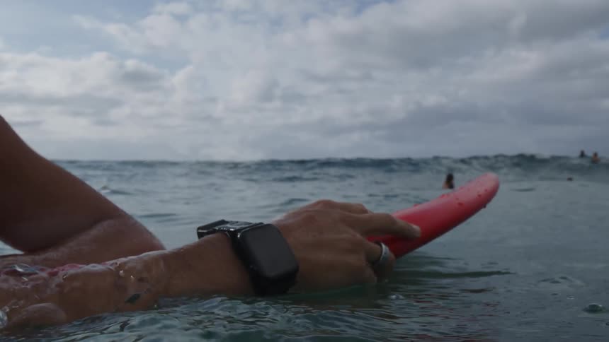 Close up of people in the open sea with surfboards