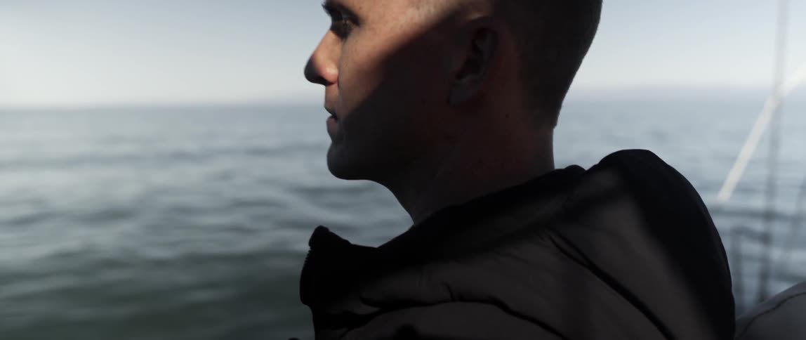 A man is overlooking the water in front of him