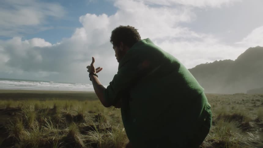 Man gesticulating alone on an island during the day