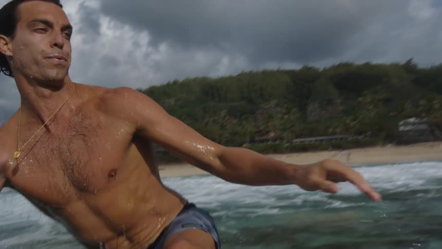 A man surfing an orange board on a summer day