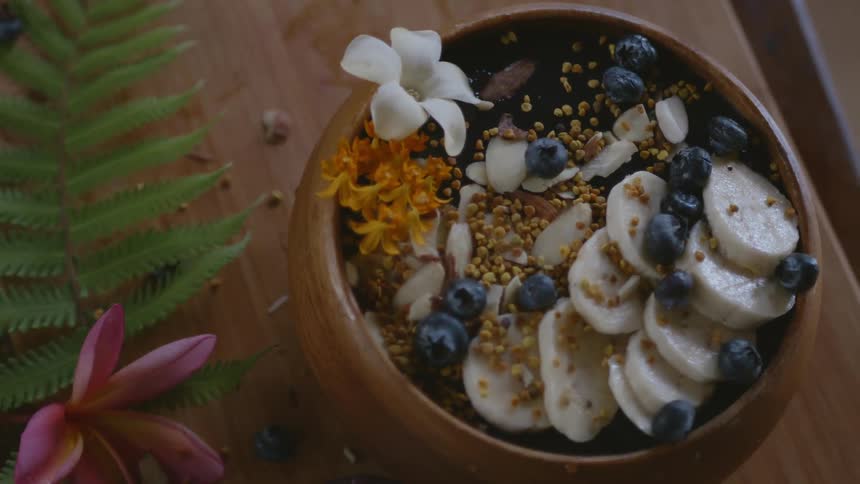Beautiful presentation of a bowl of berries and fruits over a table