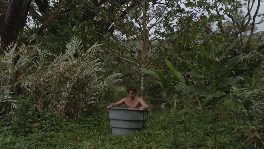 A man sits in the large bucket