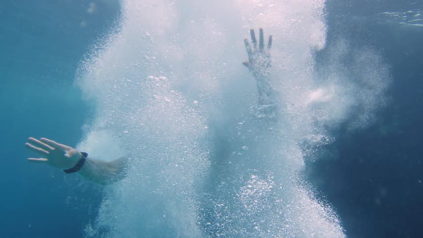 Underwater footage of a man jumping in the ocean