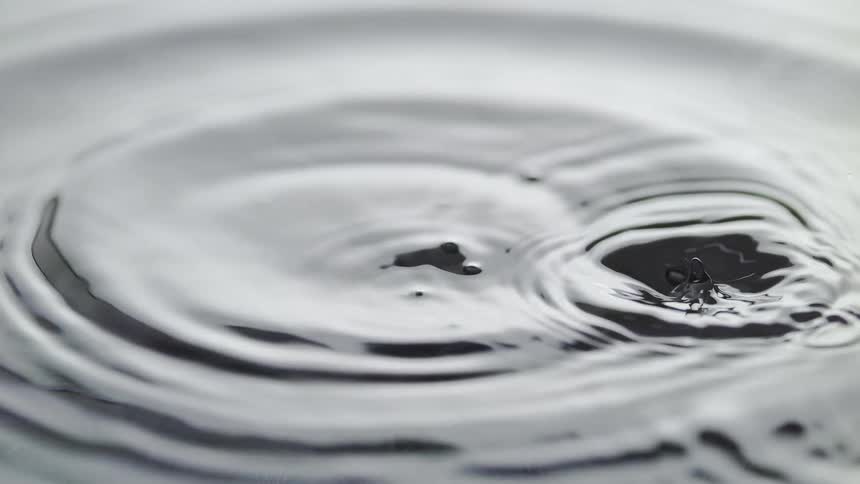 Slow motion of a droplet falling into the water and forming ripples