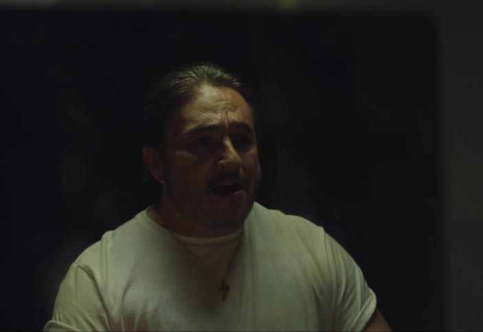 A man looking at himself in the mirror while singing by opening his mouth wide