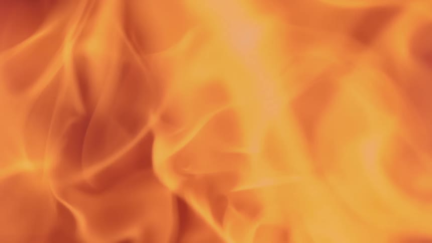 Orange glowing wispy flames slowly rise