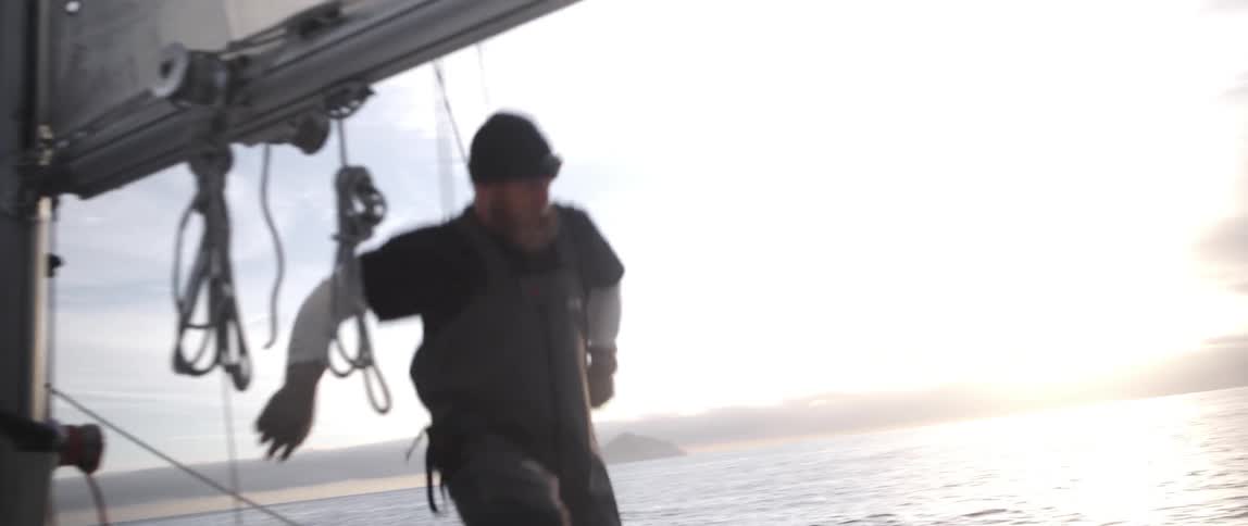 People are working on a boat on a cloudy day