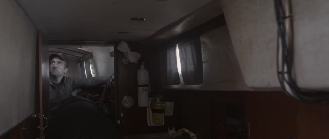 A man talking inside the cabin of a boat