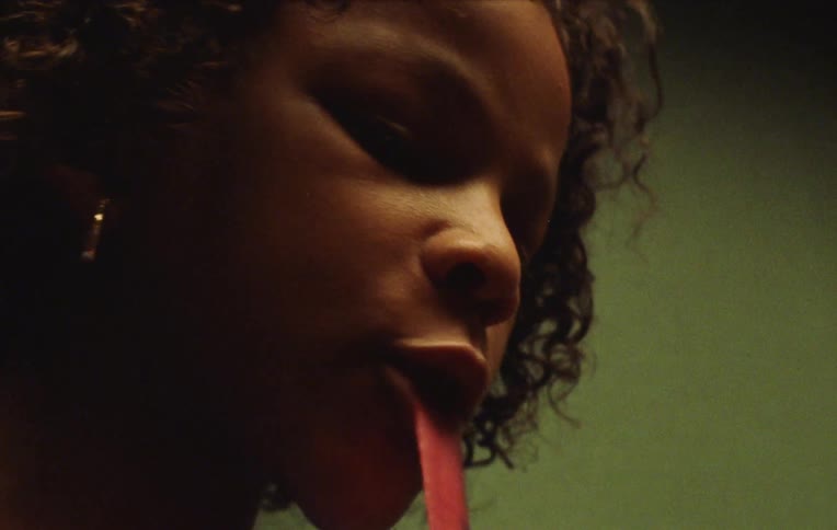 Young female friends chew ribbons of food