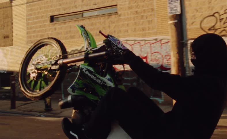 Man doing a wheelie on a motocross bike