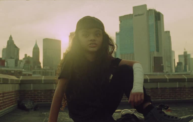 A girl on the terrace of a building at sunset