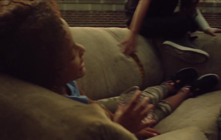 Children sitting on a sofa or on the floor talking to each other