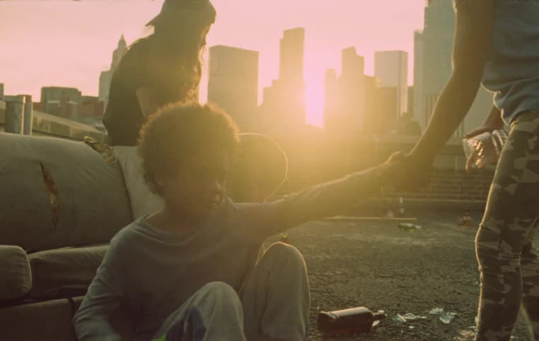 Children on the terrace of a building and one of them is crying then the girl goes to him takes his hand and they start running