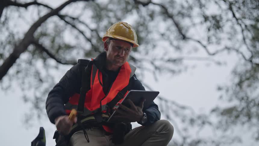A man wearing a yellow hard hat was surveying the area