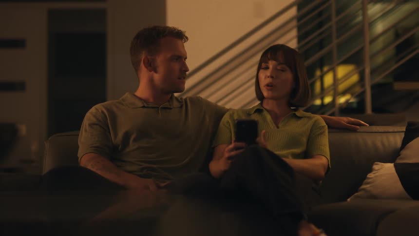 A couple arguing on the couch at home