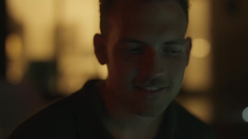 A happy man in a dark environment at night