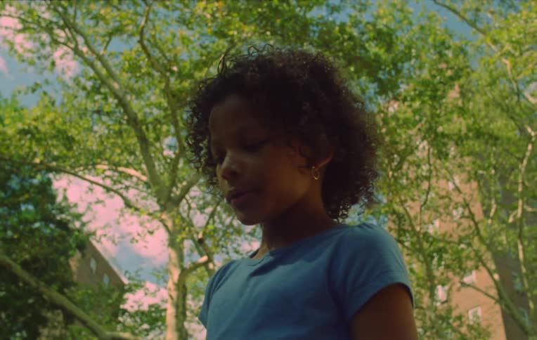 A girl talking to two other children and then they start walking