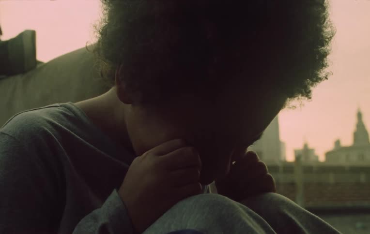 A child rubbing their eyes and crying