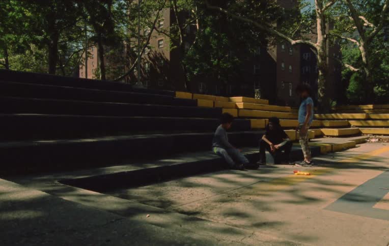 Children play in a courtyard surrounded by trees